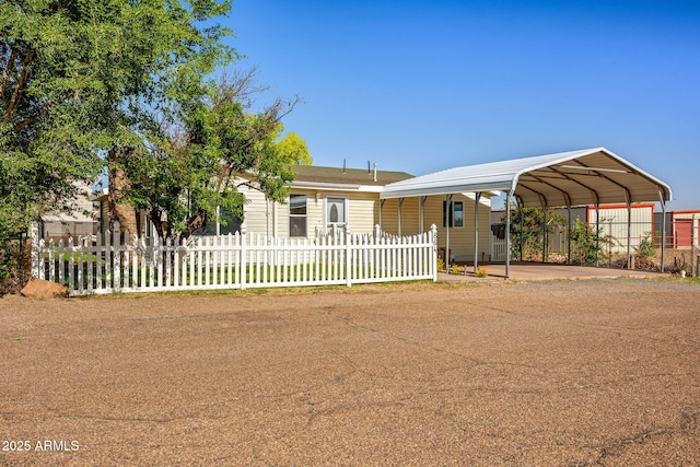 864 S 1st St, Snowflake, AZ 85937 - view of front of home featuring a detached carport, a fenced front yard, and driveway