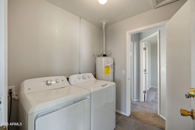 864 S 1st St, Snowflake, AZ 85937 - washroom with washing machine and dryer, electric water heater, dark tile patterned flooring, baseboards, and dark colored carpet