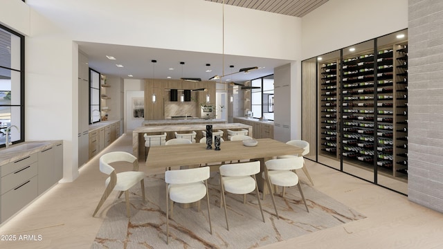 dining room featuring sink and a high ceiling