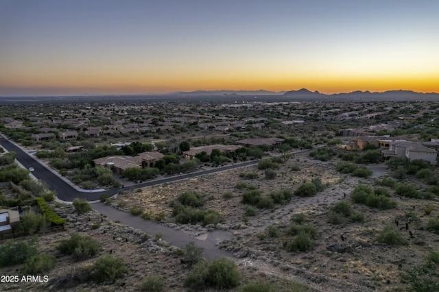 aerial view at dusk featuring a mountain view