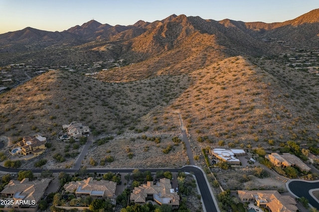 aerial view at dusk featuring a mountain view