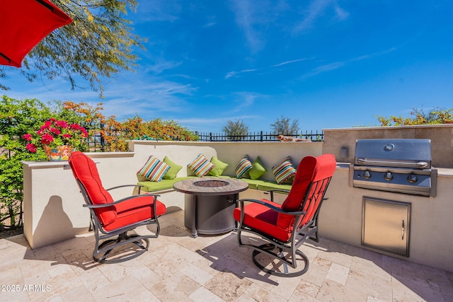 view of patio with a grill, a fire pit, and exterior kitchen