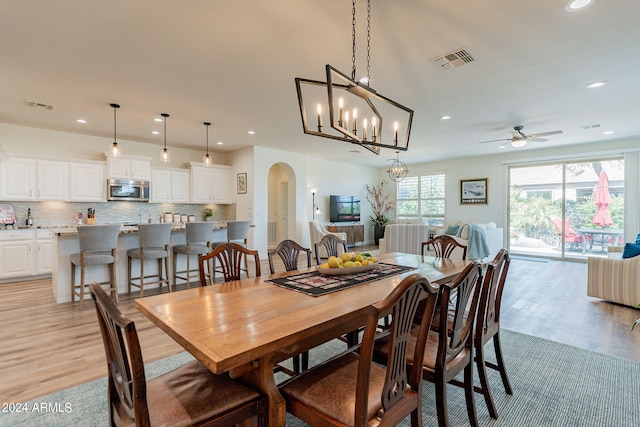 dining room with light hardwood / wood-style floors and ceiling fan