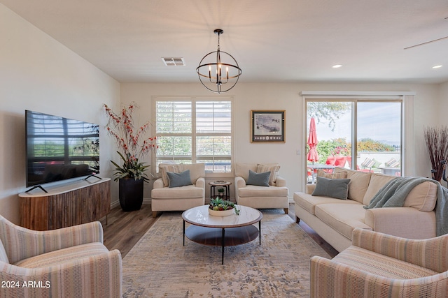 living room featuring hardwood / wood-style flooring and a notable chandelier