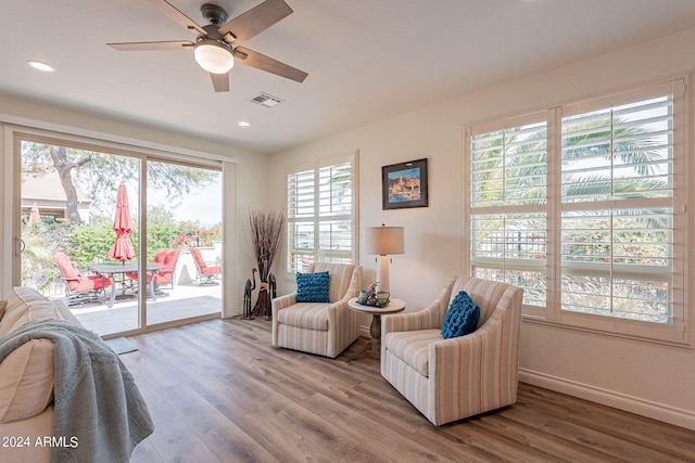 living area featuring hardwood / wood-style flooring and ceiling fan