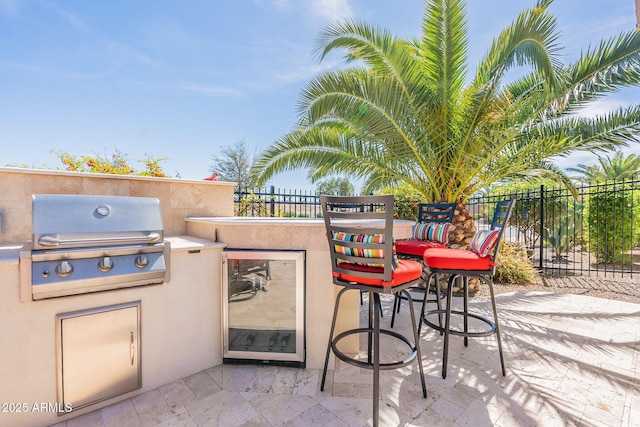 view of patio / terrace featuring an outdoor kitchen, a grill, and a bar