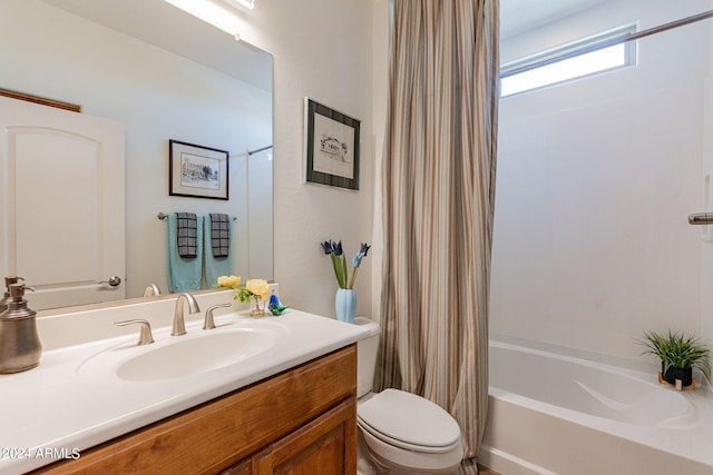 full bathroom featuring vanity, shower / bath combo, and toilet