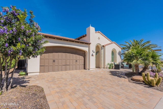 mediterranean / spanish home featuring a garage