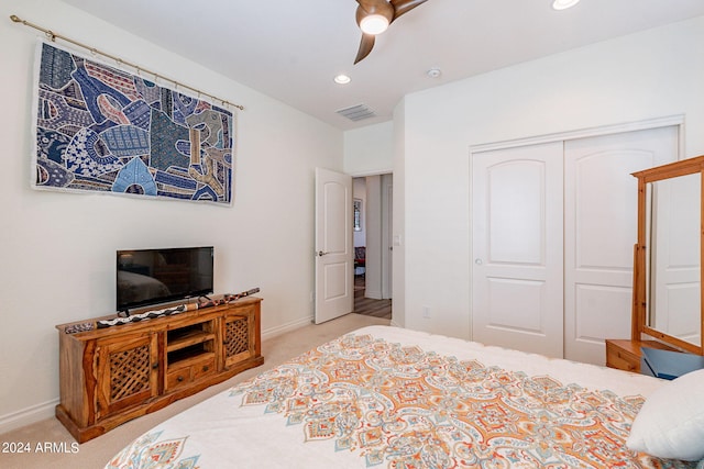 carpeted bedroom with a closet and ceiling fan