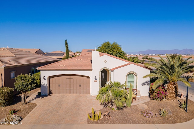 view of front facade with a garage and a mountain view