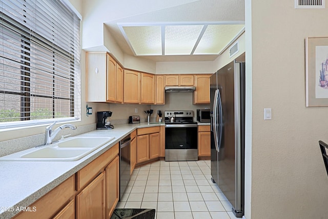 kitchen with sink, light tile patterned floors, and stainless steel appliances