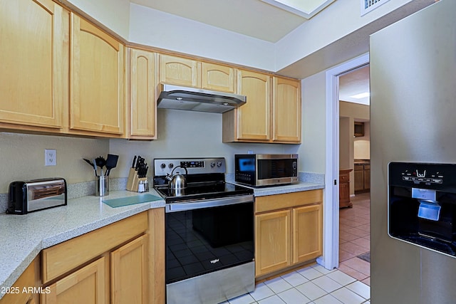 kitchen featuring light tile patterned flooring, stainless steel appliances, and light brown cabinets