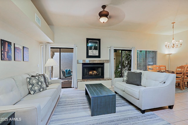 living room featuring tile patterned flooring and a chandelier