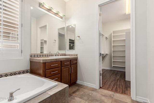 4332 S Oregon Ct, Chandler, AZ 85248 - full bathroom featuring vanity, a walk in closet, a bath, and tile patterned floors