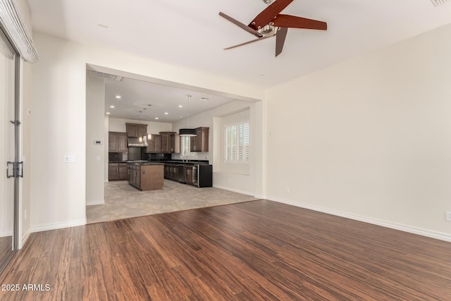 4332 S Oregon Ct, Chandler, AZ 85248 - unfurnished living room featuring light wood finished floors, a ceiling fan, and baseboards