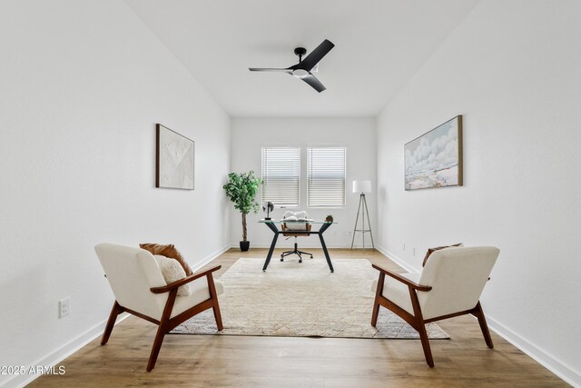 office space with baseboards, a ceiling fan, and wood finished floors