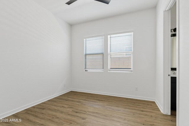 unfurnished room featuring ceiling fan, baseboards, and light wood finished floors