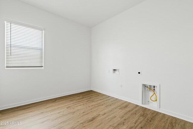 washroom with laundry area, hookup for a washing machine, light wood-style floors, hookup for a gas dryer, and hookup for an electric dryer