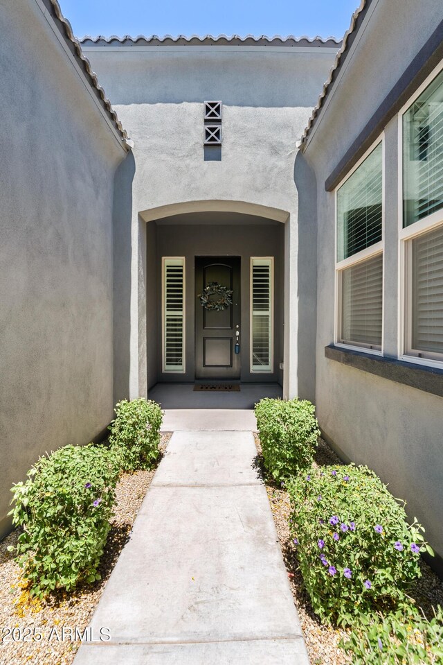 doorway to property with stucco siding