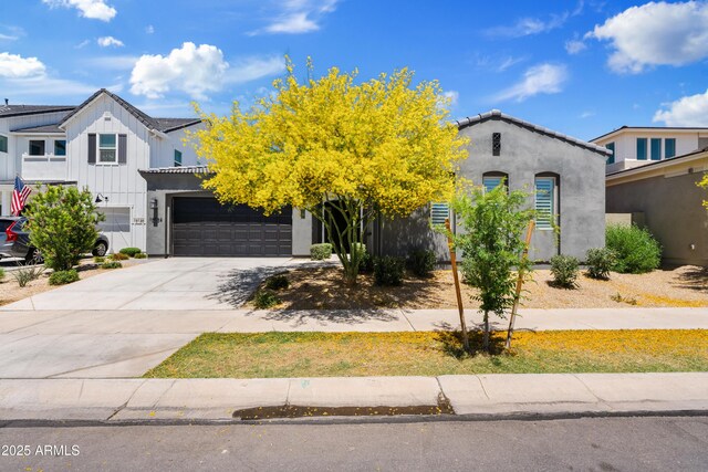 view of front of home with stucco siding, an attached garage, and driveway