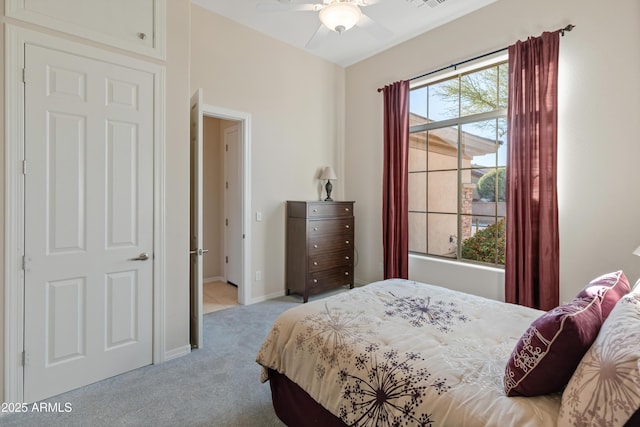 carpeted bedroom featuring ceiling fan and multiple windows