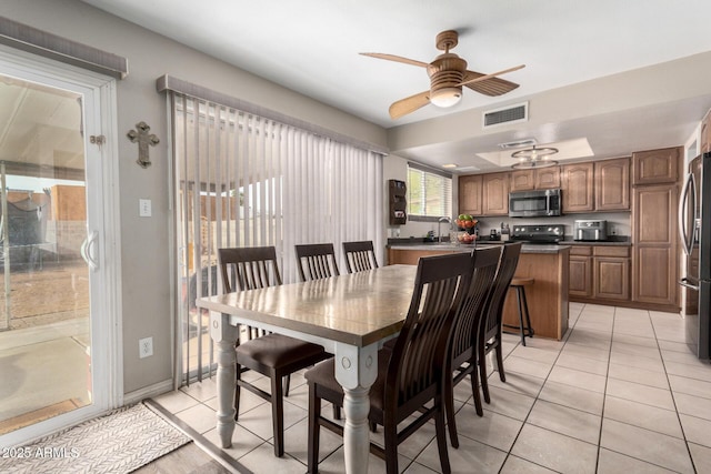 dining room with ceiling fan, light tile patterned flooring, and visible vents