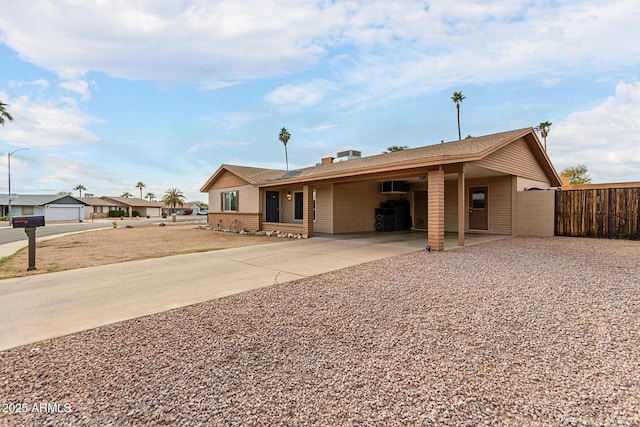 view of front of house featuring fence and concrete driveway