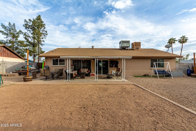 back of property with brick siding, a fenced backyard, a patio area, and cooling unit