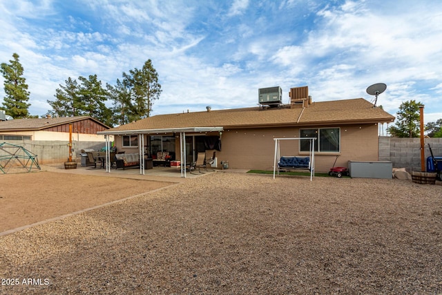 back of house with a patio area, central AC, and a fenced backyard