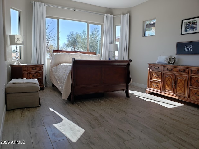 bedroom featuring light wood-style flooring and baseboards