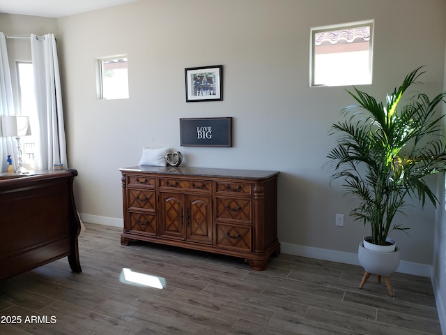 living area with baseboards and wood finish floors