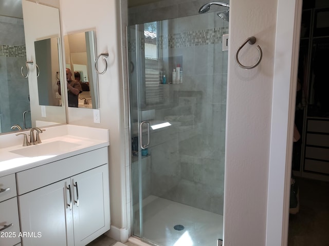 full bath featuring a stall shower and vanity