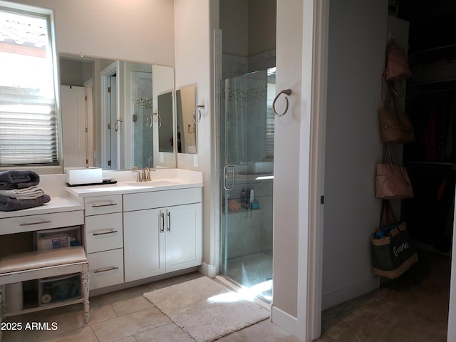 bathroom with a shower stall, vanity, and tile patterned floors