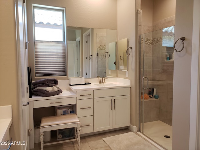 bathroom with a stall shower, tile patterned flooring, and vanity