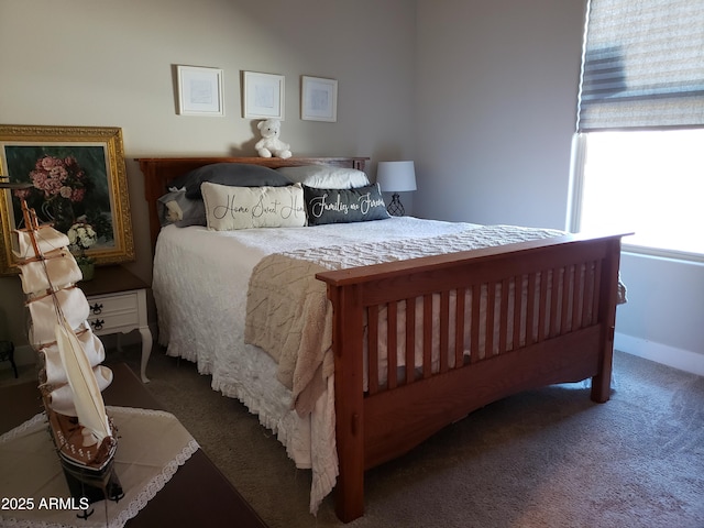 carpeted bedroom featuring baseboards