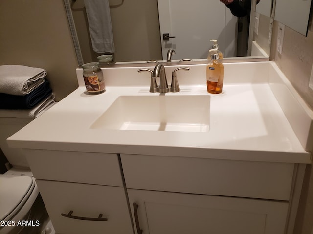 bathroom featuring toilet and vanity