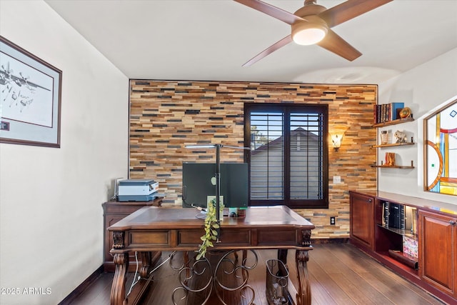 home office with dark hardwood / wood-style floors and ceiling fan