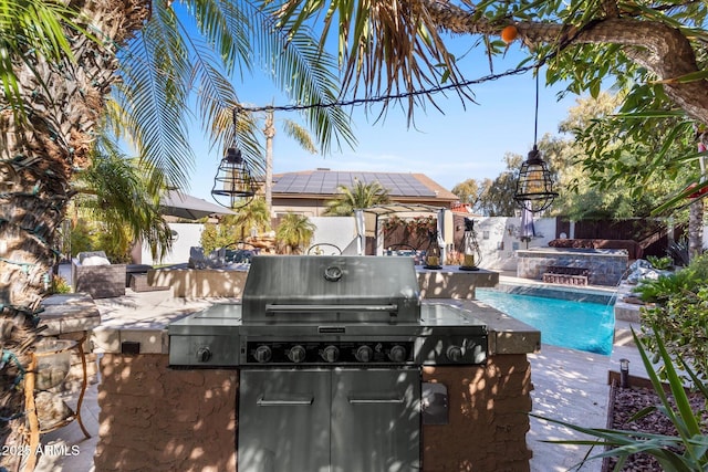 view of pool featuring area for grilling, a patio, and pool water feature