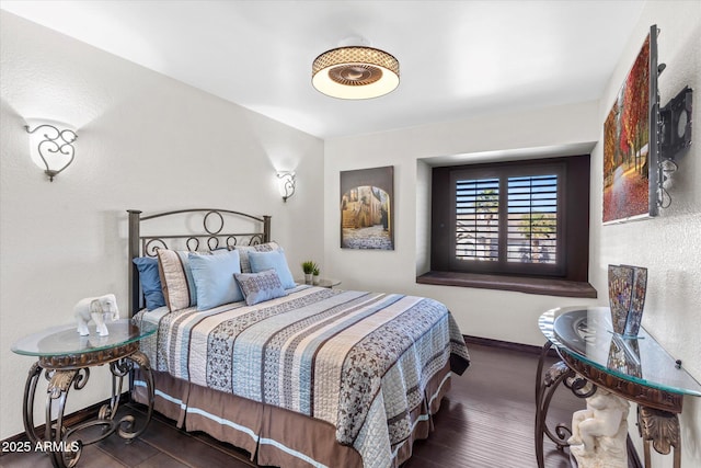 bedroom with dark hardwood / wood-style floors