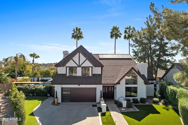 view of front facade with a garage and a front lawn