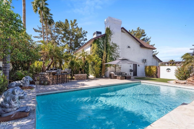 view of pool with an outdoor hangout area, an outdoor bar, and a patio