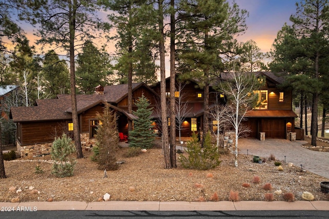 log-style house featuring a garage