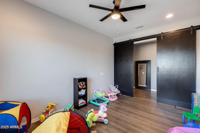 9723 W Patrick Ln, Peoria, AZ 85383 - rec room with a barn door, a ceiling fan, baseboards, wood finished floors, and recessed lighting