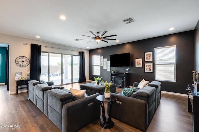 9723 W Patrick Ln, Peoria, AZ 85383 - living room with recessed lighting, a ceiling fan, dark wood-type flooring, baseboards, and a glass covered fireplace