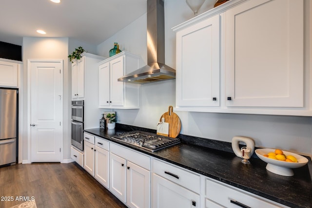 9723 W Patrick Ln, Peoria, AZ 85383 - kitchen with stainless steel appliances, wall chimney range hood, white cabinets, dark wood-type flooring, and recessed lighting