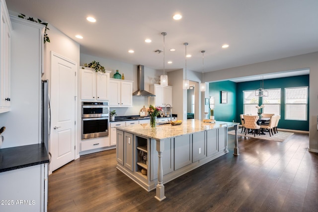 9723 W Patrick Ln, Peoria, AZ 85383 - kitchen with wall chimney range hood, stainless steel appliances, a kitchen island with sink, recessed lighting, and dark wood-style flooring