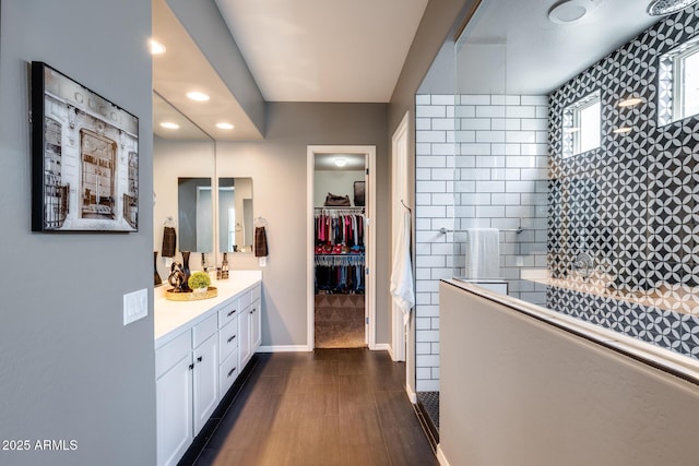 9723 W Patrick Ln, Peoria, AZ 85383 - full bathroom featuring vanity, walk in shower, recessed lighting, a spacious closet, and baseboards