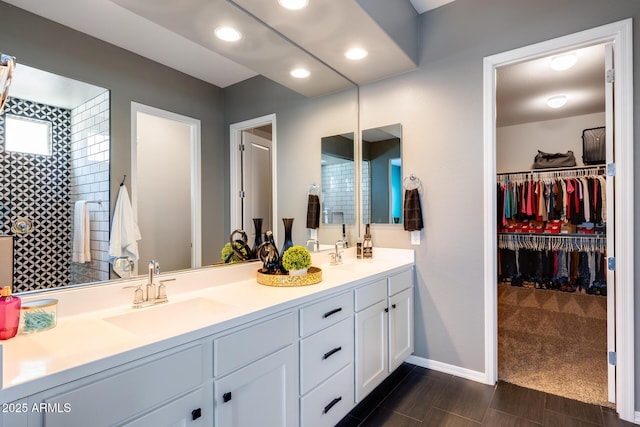 9723 W Patrick Ln, Peoria, AZ 85383 - full bathroom featuring double vanity, baseboards, a walk in closet, and recessed lighting