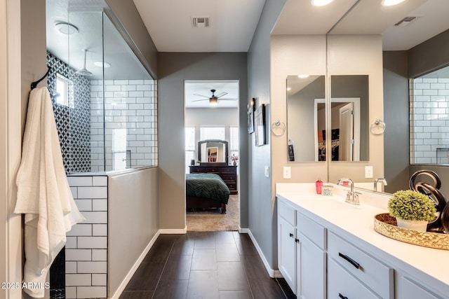 9723 W Patrick Ln, Peoria, AZ 85383 - full bath with vanity, walk in shower, ensuite bathroom, a ceiling fan, and baseboards