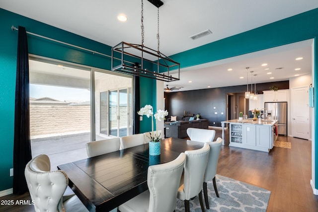 9723 W Patrick Ln, Peoria, AZ 85383 - dining area with recessed lighting, dark wood-type flooring, beverage cooler, and baseboards